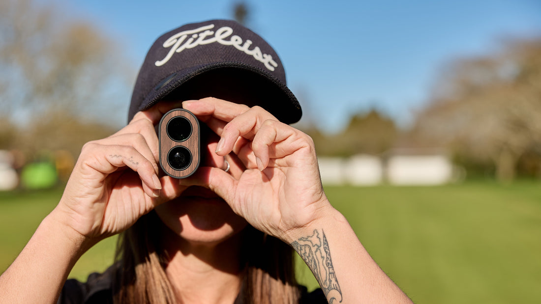 Close up of woman using a rangefinder on golf course